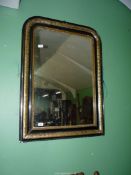 An ebonised and gilt detail framed wall hanging mirror, 41" high x 30" wide.