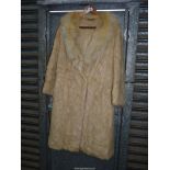 A lady's honey coloured fur Coat with shawl collar and pelts stitched in diagonal and triangular