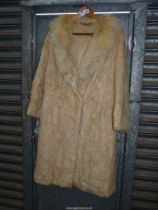 A lady's honey coloured fur Coat with shawl collar and pelts stitched in diagonal and triangular