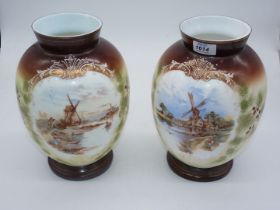 A pair of white glass vases with painted scenes of windmills on brown and green ground,