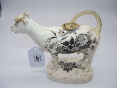 A circa 1830 Dilwyn Swansea black transfer printed cow creamer with shells and flower decoration,