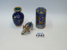 A Cloisonne needle case (2"), baluster vase (2") and a miniature elephant.