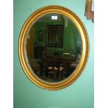 An early 19th century oval gesso Mirror with bead decoration, 25 1/2" x 22 1/2".