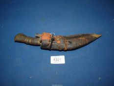 **A miniature Gurkha type Kukri having a wood and metal handle and together with a leather sheath