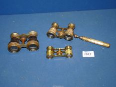 Three pairs of opera glasses, one with Mother of Pearl finish and articulating handle.