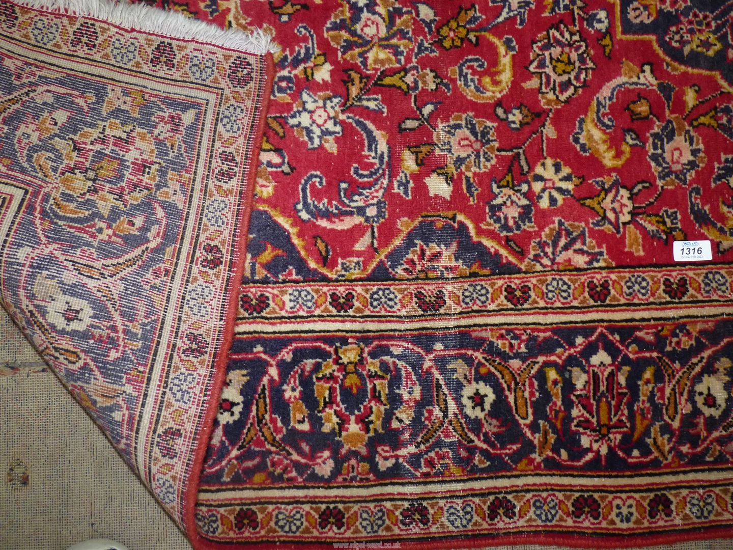 A navy/red/cream and floral patterned rug, 56" x 92". - Image 2 of 2
