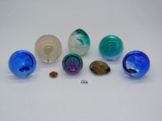 A quantity of Caithness paperweights to include dolphins, pink Dahlia, etc.