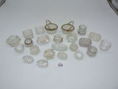A quantity of glass salts some in basket form, one having silver rim.