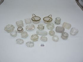 A quantity of glass salts some in basket form, one having silver rim.