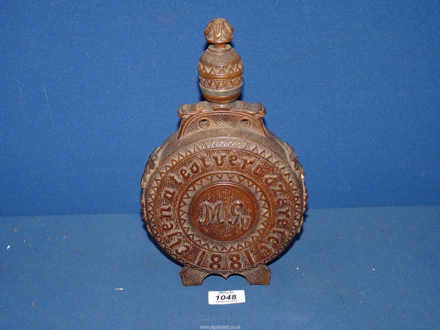 A 19th century Austrian heavily carved decorative moon shape circular wooden Flask with coat of