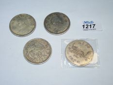 Four large reproduction Chinese coins, three with portraits, one with dragon, 107.5g total.