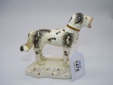 A 19th century Staffordshire black and white dog, [some hairline cracks] 5" wide x 5" tall.