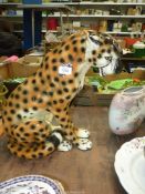 A large ceramic leopard in sitting position, 18" tall.