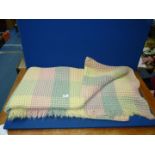 A single Welsh wool waffle blanket, yellow/pink/green.