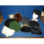 A box of hats, etc., to includes berets and a handbag.