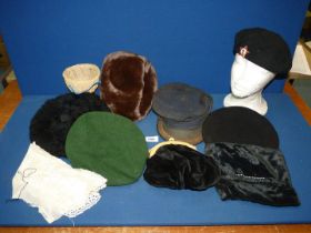 A box of hats, etc., to includes berets and a handbag.