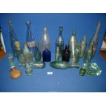 A quantity of glass bottles including Codd bottles, wicker bound flask, Bristol blue bottle, etc.