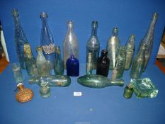 A quantity of glass bottles including Codd bottles, wicker bound flask, Bristol blue bottle, etc.