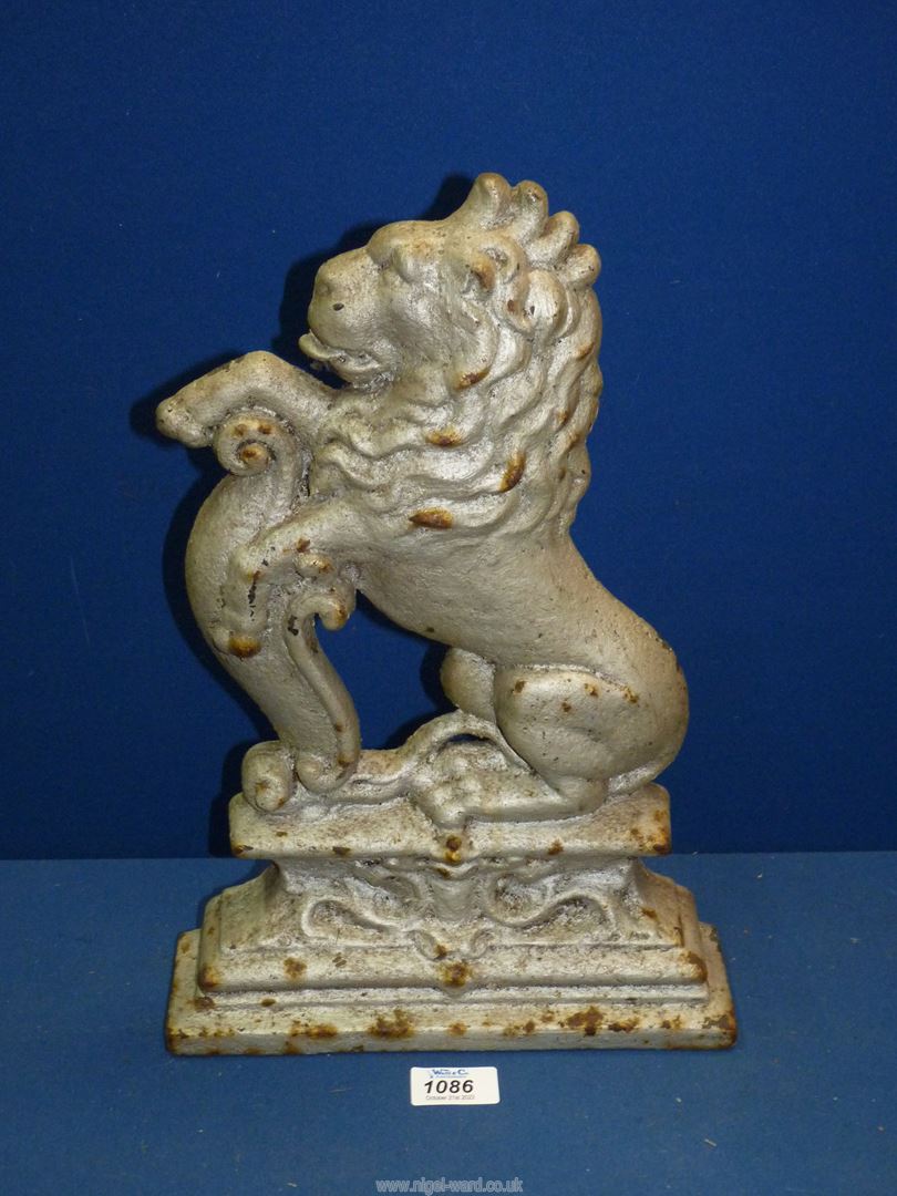 A Doorstop in the form of a lion on its haunches, 15 1/4" tall.