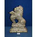 A Doorstop in the form of a lion on its haunches, 15 1/4" tall.