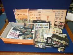 A cardboard box of stamps and part stock books.