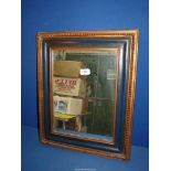 A mahogany framed wall mirror having inner part of frame painted black,