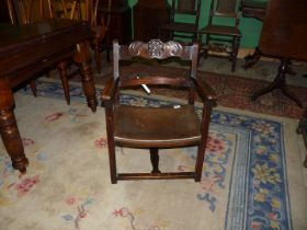 A Mahogany framed open armed armchair having a floral and leaf-scroll decorated top rail,