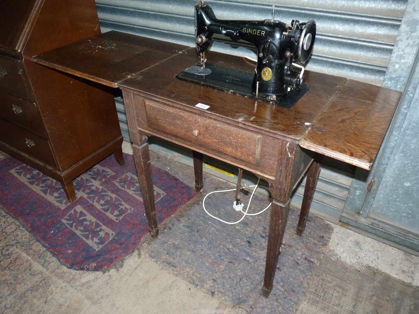 An Oak table contained Metamorphic Singer electric sewing machine folding down to form a table when - Image 4 of 7