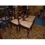 A set of six Rosewood balloon back dining chairs standing on turned eight-sided front legs and