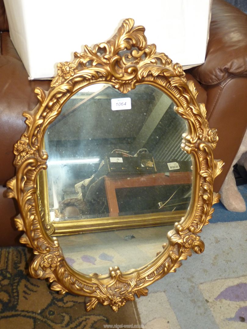 An oval Mirror with decorative gilt surround (glass loose), 25" x 18".