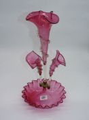 A Victorian cranberry glass Epergne having three flutes and a bon bon dish to the base 18" tall.