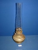 A brass Aladdin paraffin lamp with clear chimney, 20" tall.