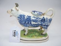 A 19th century Staffordshire pottery cow creamer with blue transfer Willow pattern,