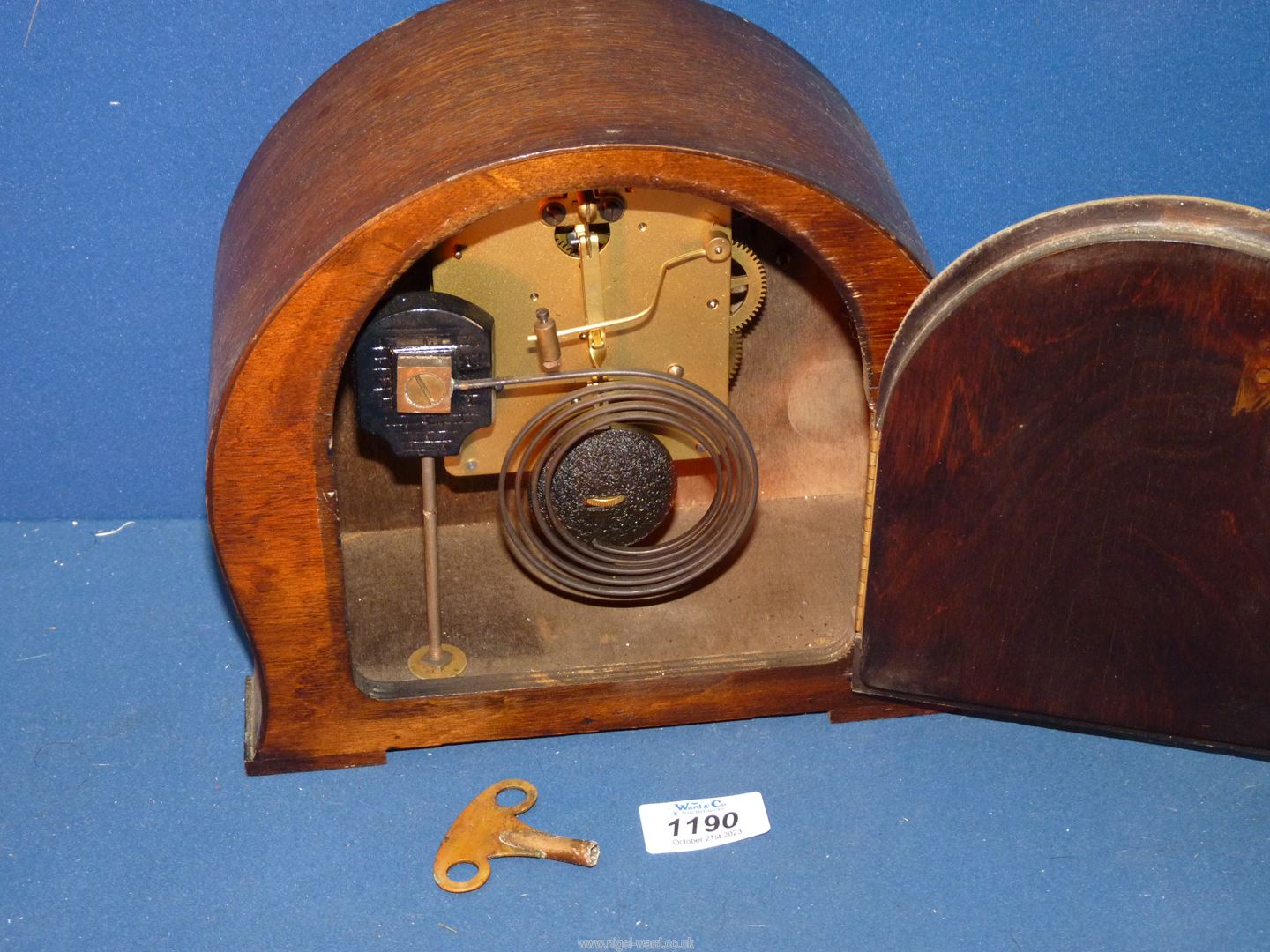 A Mantle clock, 9'' wide x 8 1/4'' high, with key and pendulum. - Image 2 of 2