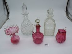 Two cut glass decanters and three pieces of Cranberry glass including: jug,