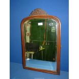 An arched and bevelled Mahogany framed dressing table mirror, 24 1/2" x 15 1/4".