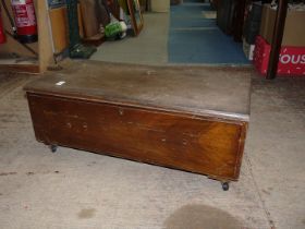 A darkwood under bed storage chest on castors, 32 1/2" x 17 1/4" x 12" high.