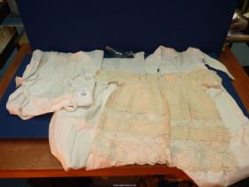 Three cotton Christening gowns, one silk Christening gown, baby booties, etc.