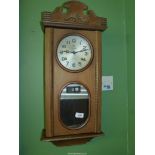 A Frontier 30 day chiming Clock in medium toned wooden case having day and date perpetual calendar