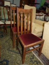 A pair of Oak framed side/dining chairs having maroon velvet type upholstered drop in-seats.