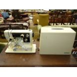 A Janome Novum Model 5000 cream cased electric sewing machine having multiple selectors/adjustments,