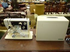 A Janome Novum Model 5000 cream cased electric sewing machine having multiple selectors/adjustments,