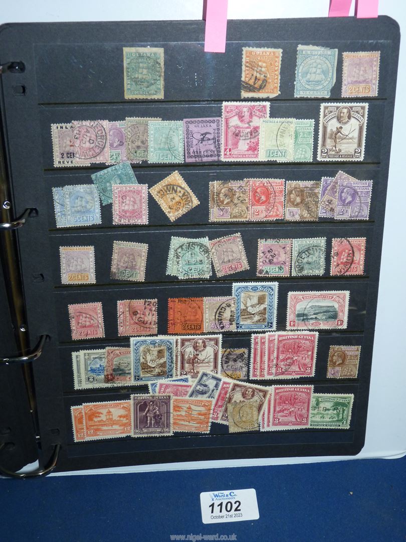 A white ring binder and contents: British Commonwealth stamps/Queen Victoria - King George VI.