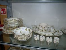 A quantity of Wedgwood 'Wild Strawberry' dinner ware and four napkin rings, one with crack to rim,