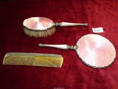 A Silver dressing table set including mirror, brush and comb,