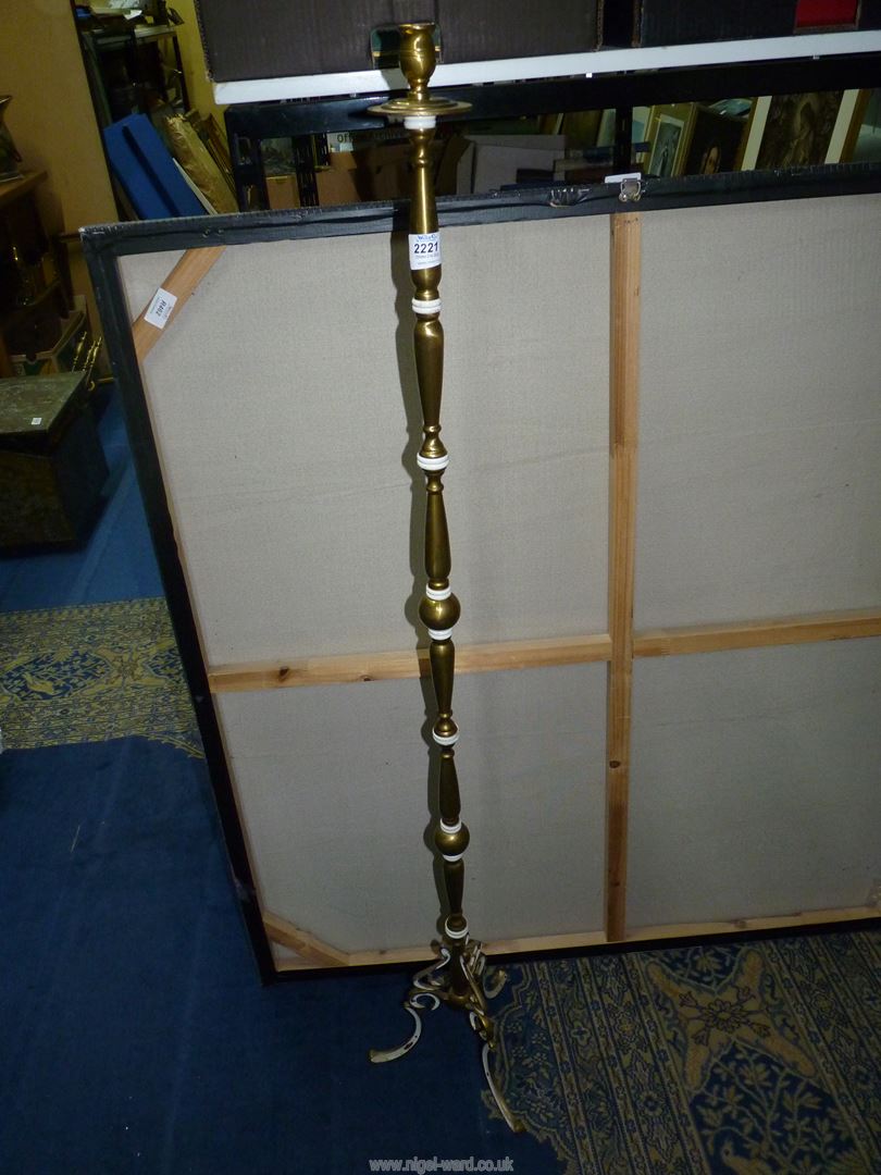 A brass floor standing Candle holder.