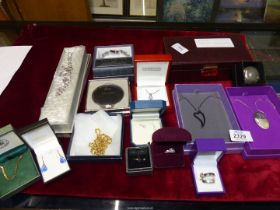 A quantity of costume jewellery including chains, rings, compact etc.