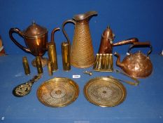 A quantity of brass to include; a chocolate pot kettle, empty shell cases, jug, plates, etc.