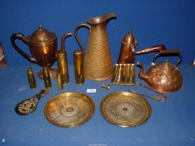 A quantity of brass to include; a chocolate pot kettle, empty shell cases, jug, plates, etc.