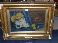 A still life in heavy gilt frame of chrysanthemums in a blue and white vase, unsigned,